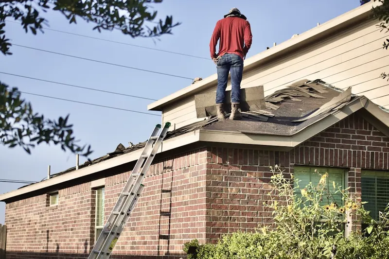 Professional roofer working on a residential roof in Staunton